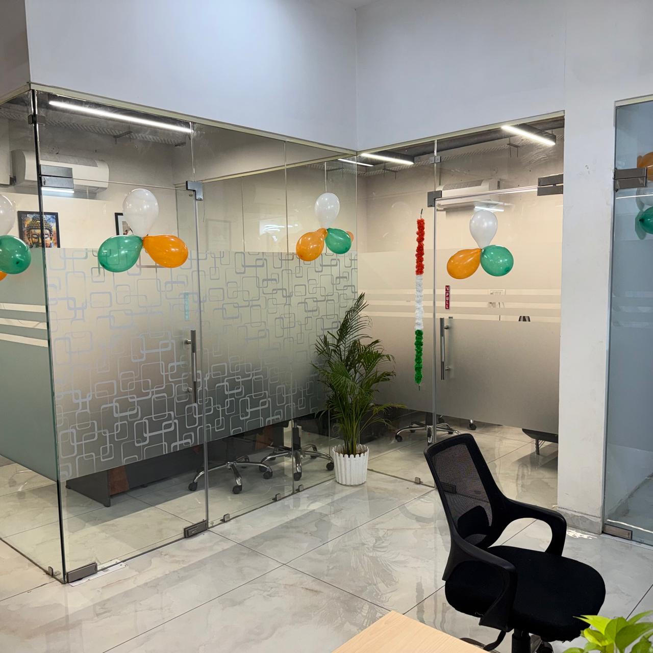 Open workstation area with glass cabins at the Vybrix Noida office