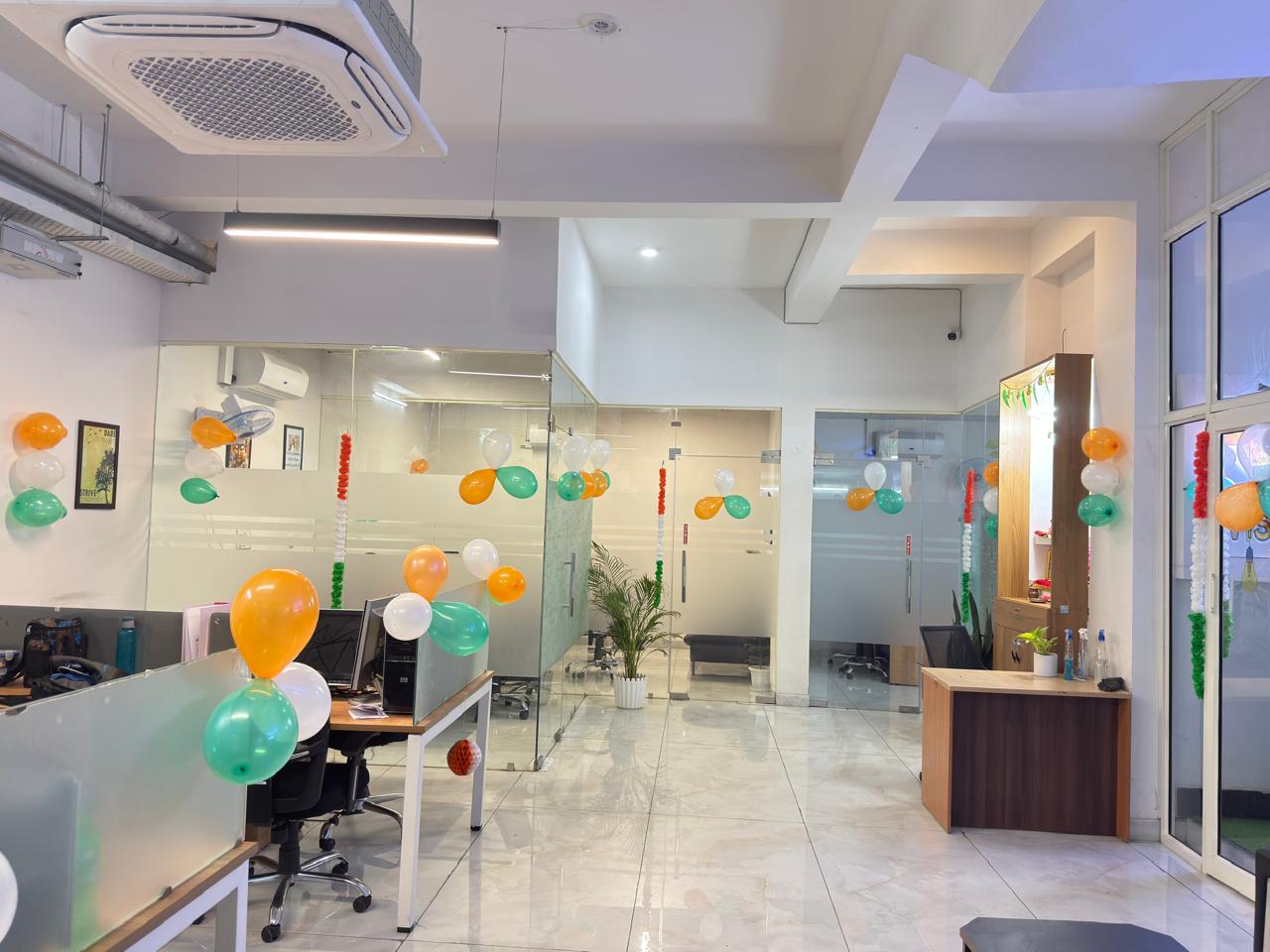 Open-plan office interior with cassette AC and glass partitions