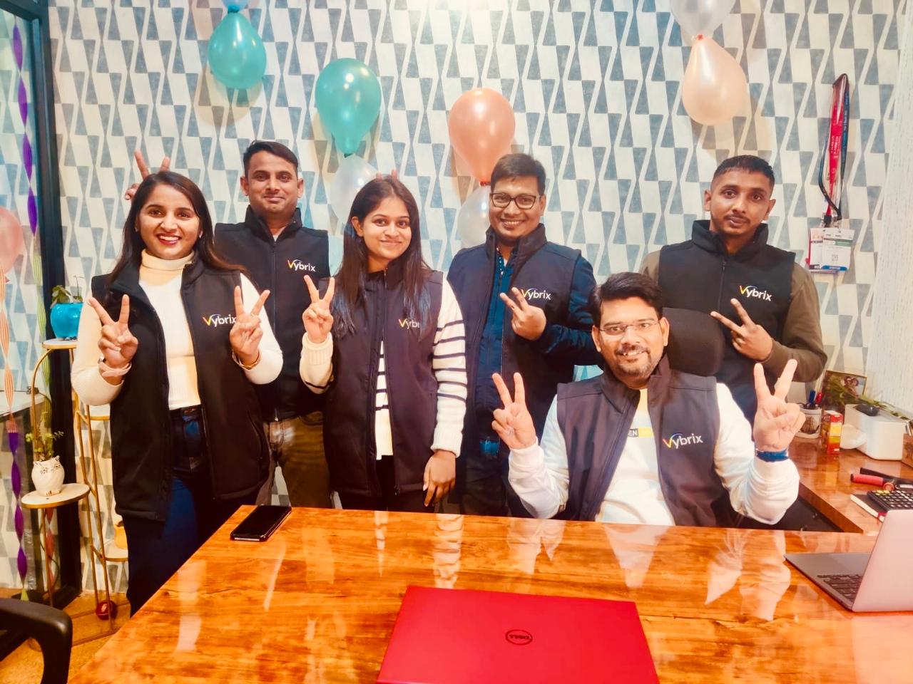 Vybrix team in branded vests at the Noida office